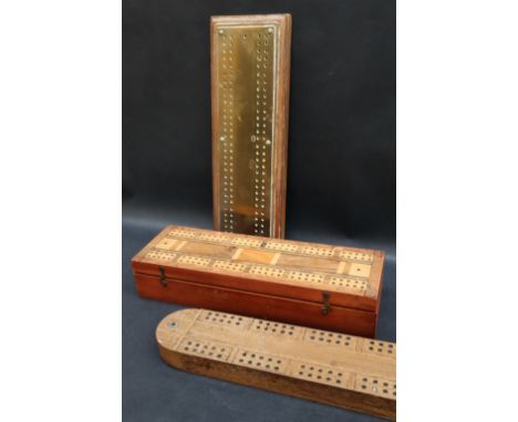 A cribbage board / games box, inlaid with various timbers the hinged top enclosing a fitted interior with compartments for pl