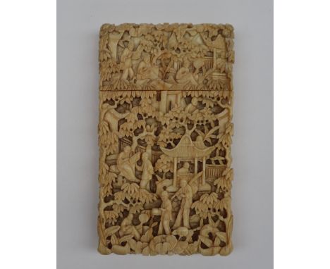 A 19th century Chinese Canton carved ivory visiting card case , profusely carved with figures, pagodas and trees, 9.5cm high 