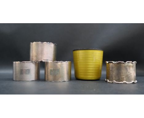 A Norwegian silver and yellow enamel decorated beaker, 5.5cm high together with a set of three and another silver napkin ring