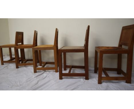 Mouseman - A set of five Robert Thompson of Kilburn, English oak dining chairs with a panelled back above a leather pad seat 