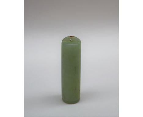 A Chinese green jade plume holder of cylindrical form, with pierced top, 5.5cm long