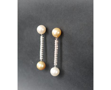 A pair of diamond and pearl drop earrings, set with a large yellow and white pearl, and eleven round brilliant cut diamonds t