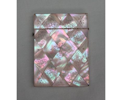 A mother of pearl card case of rectangular form, with geometric panels decorated with leaves, 105mm high 