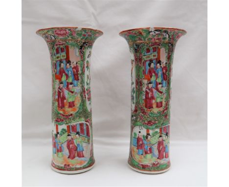 A pair of Cantonese porcelain vases with a flared rim and cylindrical body, painted with panels of figures and birds, 24.5cm 