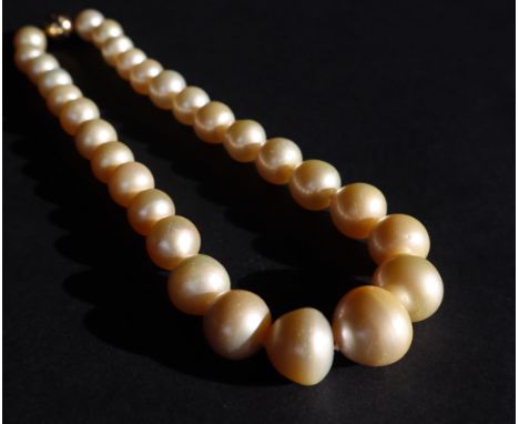 A pearl necklace, set with twenty nine irregular shape pearls to an 18ct yellow gold diamond set ball clasp, approximately 11