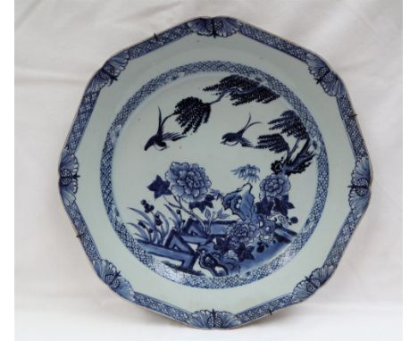 A Chinese porcelain charger of octagonal form, decorated to the centre with a fence pattern with birds of paradise and flower