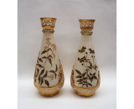 A pair of Royal Worcester porcelain vase with a pierced flared top above a tapering body decorated with flowers and leaves to