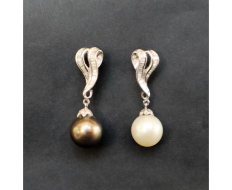 A pair of pearl and diamond drop earrings, one with a black pearl, the other with a white pearl set with baguette and round b