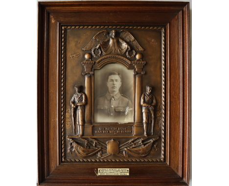 A World War I bronzed plaster plaque "The Path of Duty Was The Way To Glory" in oak frame, inset with a black and white photo