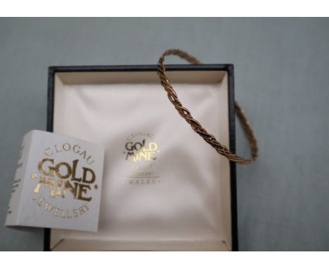 Welsh gold - A 9ct yellow gold Clogau bangle of twisted form, approximately 7 grams, boxed