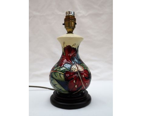 A Moorcroft pottery table lamp decorated with lilies and leaves, 39.5cm high overall