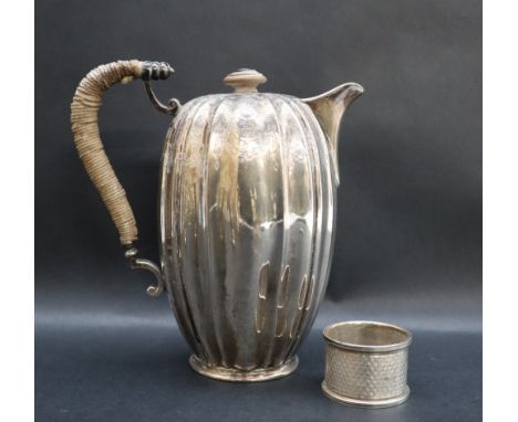 An Edward VII silver hot water pot of elongated melon shape decorated with swags and flowerheads to a rope twist handle, Lond