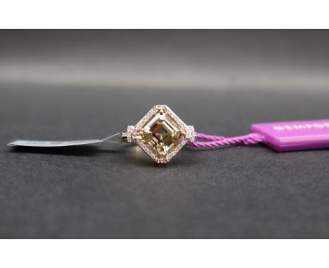 Gemporia - An asscher cut csarite and diamond 18k gold ring, with a 2.9ct octagon shape csarite and baguette and round cut di