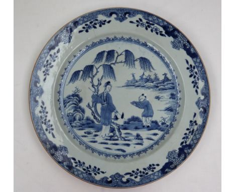 A Chinese blue and white porcelain charger, painted to the centre with figures by a tree, the border with leaves and flowers,