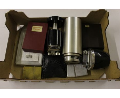 A box containing various cigarette lighters, cigarette case etc.