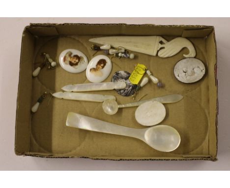 A tray of enamel and porcelain plaques and mother of pearl items
