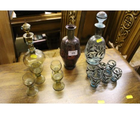 A silver overlaid glass liqueur set together with one other liqueur set and an amethyst and white metal overlaid liqueur bott