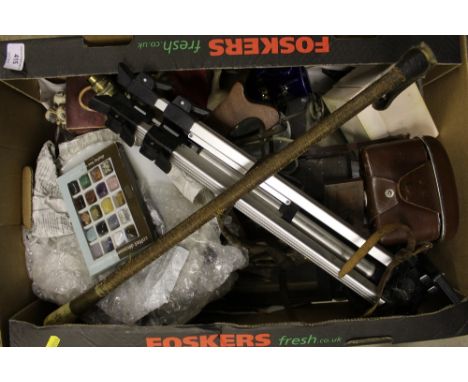 A box of various sundries to include a camera and tripod, a crucifix, riding crop etc.