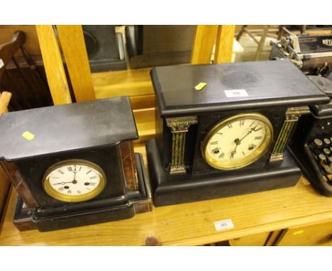 A black slate and marble two hole mantel clock, AF; together with an ebonised and marble effect mantel clock