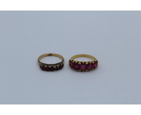 Two ruby set half hoop rings, one, which tests as 18ct gold, is set with five square cut rubies, with the largest measuring 5