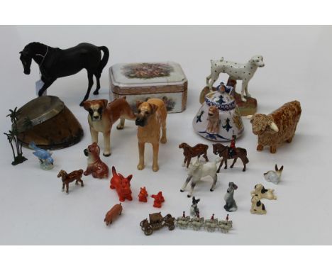 A collection of assorted ceramic figures, to include a Beswick Black Beauty, a Staffordshire dalmatian, a polar bear, a Highl