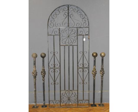 A collection of iron items, comprising a tall garden gate of scrolling form, a set of four iron posts with ball finials and o