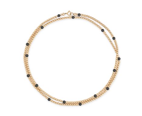 A VINTAGE ONYX AND GOLD BEAD NECKLACE in 14ct yellow gold, comprising a single row of gold beads accented by polished onyx be