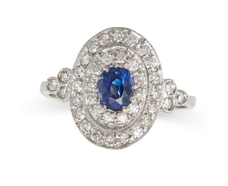 A SAPPHIRE AND DIAMOND CLUSTER RING in platinum, set with an oval cut sapphire in a double border of single cut diamonds, the