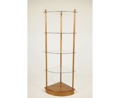 A 20th Century oak and glass corner shelf unitWith four bowfront glass shelves raised on turned cylindrical supports upon a b