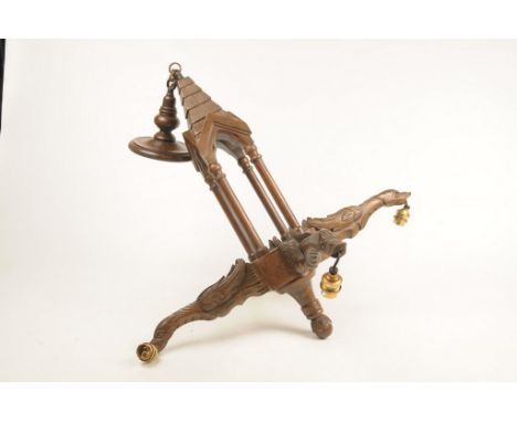 A French carved wooden four-branch ceiling pendant The bevelled sconce extending to architectural four pillar stem, and termi