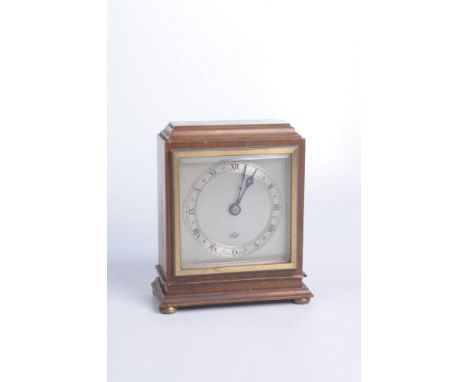 An Elliott mantel clock, early to mid 20th CenturyThe square bevelled case with silvered square dial and applied silvered cha