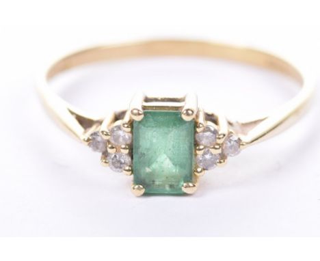 An emerald and diamond ringThe step-cut emerald to round brilliant-cut diamond shoulders, to an 18ct gold shank, weight 2.2g