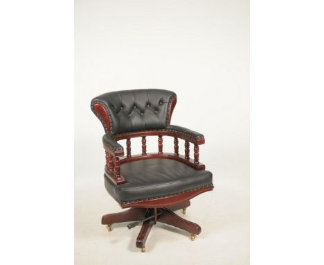 A reproduction leather and mahogany effect captains chairWith a padded button down rail raised on ten substantial ring turned