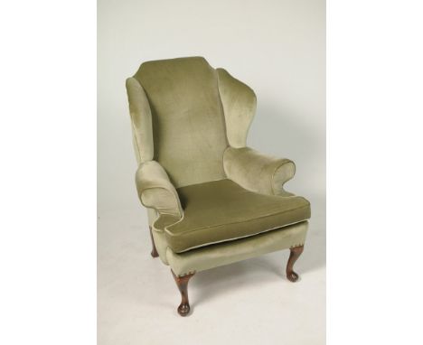 A George ll style wing back fireside armchair, early 20th CenturyThe caddy shaped padded back above outswept wing backs and a