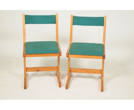 A pair of Gordon Warr pine framed chairs, circa 1975Each chair with a concave rail raised on bracket supports with a plain cr