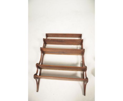 A late Victorian walnut hanging wall shelf With five graduated shelves divided by c-shaped supports, 77 x 112 x 27cm.