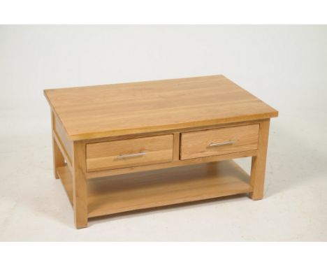 A contemporary light oak centre tableThe rectangular top above two frieze drawers with brushed metal bar handles over an unde