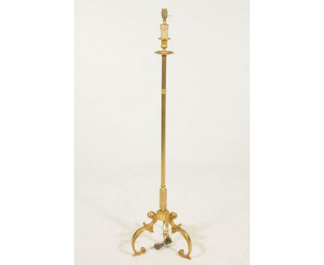 A gilt metal standard lamp The three 'S' scroll base, rising to a reeded central shaft, and terminating at a faux candle and 