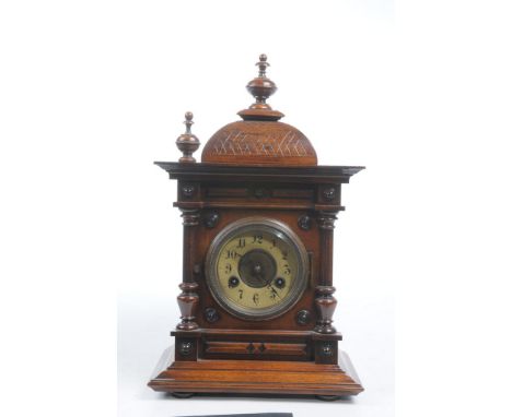 A German 19th Century oak cased bracket clock The architectural case with domed top and turned finial, housing a white enamel