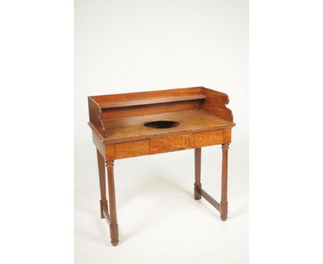 A 19th Century mahogany wash standThe galleried top with a rear shelf above a circular aperture and a pair of frieze drawers 