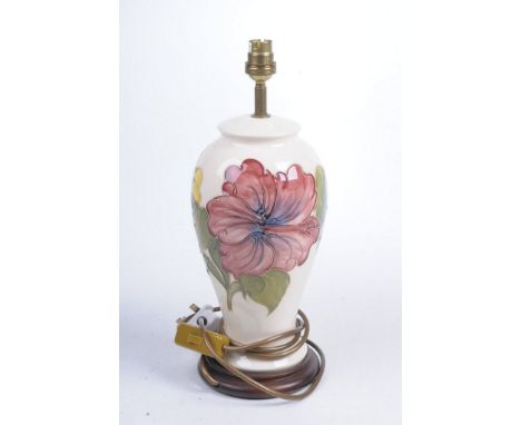 A Moorcroft 'Hibiscus' pattern table lamp The ivory ground tubeline decorated with pink flowerhead, mounted on wooden base, 2