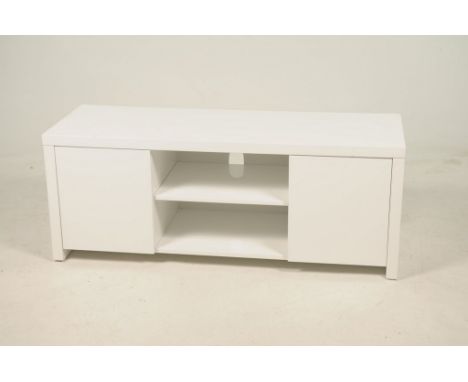 A contemporary white TV standWith a central open shelf flanked by two cupboard doors, 130x51x45cms