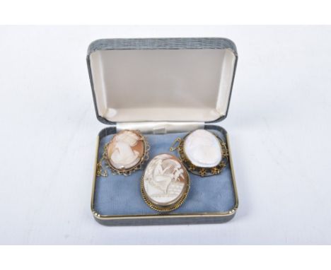 A 9c gold cameo brooch Depicting a harp playing woman and putties, together with, two 9ct gold cameo brooches (3) 