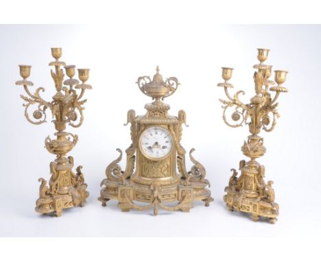 A French gilt metal Louis XV1 style clock garniture, late 19th CenturyThe central clock of scalloped quatrefoil form, raised 