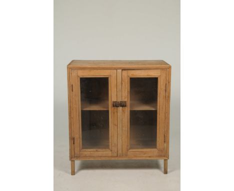 A Victorian glazed pine cabinet With a pair of glazed doors enclosing a single shelf, 95x107x44cms