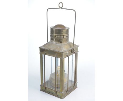 A brass oil lampIn the form of a four glass lantern with pierced funnel top, interior burner and swing handle, 37cm high.