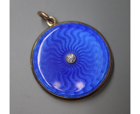 A Victorian yellow metal blue enamel and single stone diamond set circular locket, 29mm.