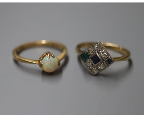 An emerald, sapphire and diamond tablet ring on 18ct shank and an 18ct and white opal-set ring.