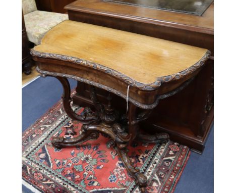 A Victorian walnut folding card table W.90cm
