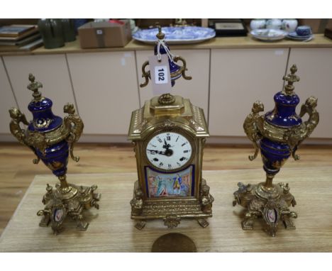 A gilt metal and porcelain mounted three piece clock garniture